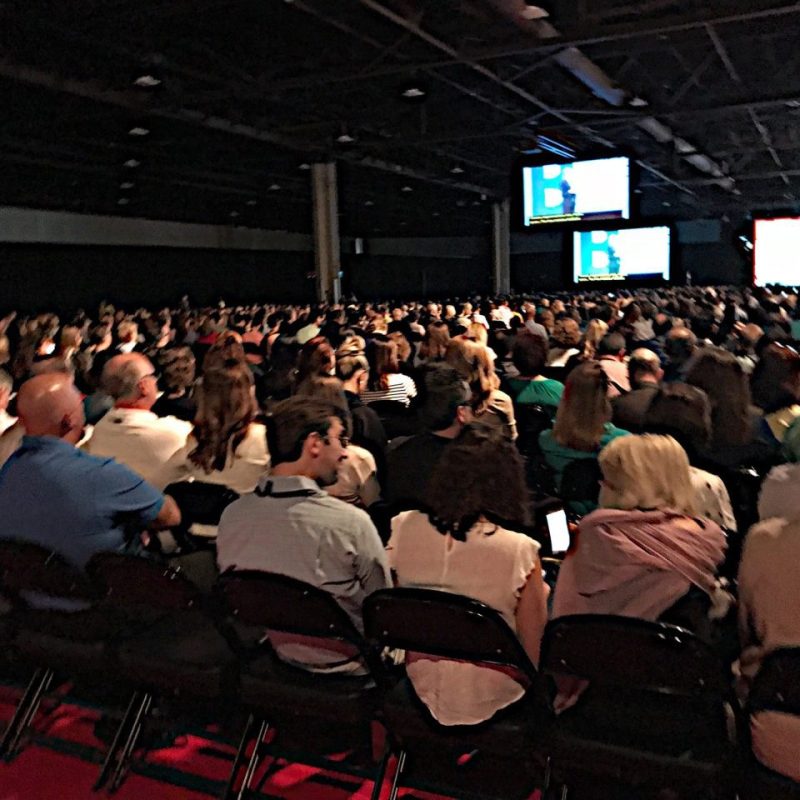 large-audience-crowd-gathering-at-a-conference-watching-the-guest-speaker-on-the-main-stage-1.jpg